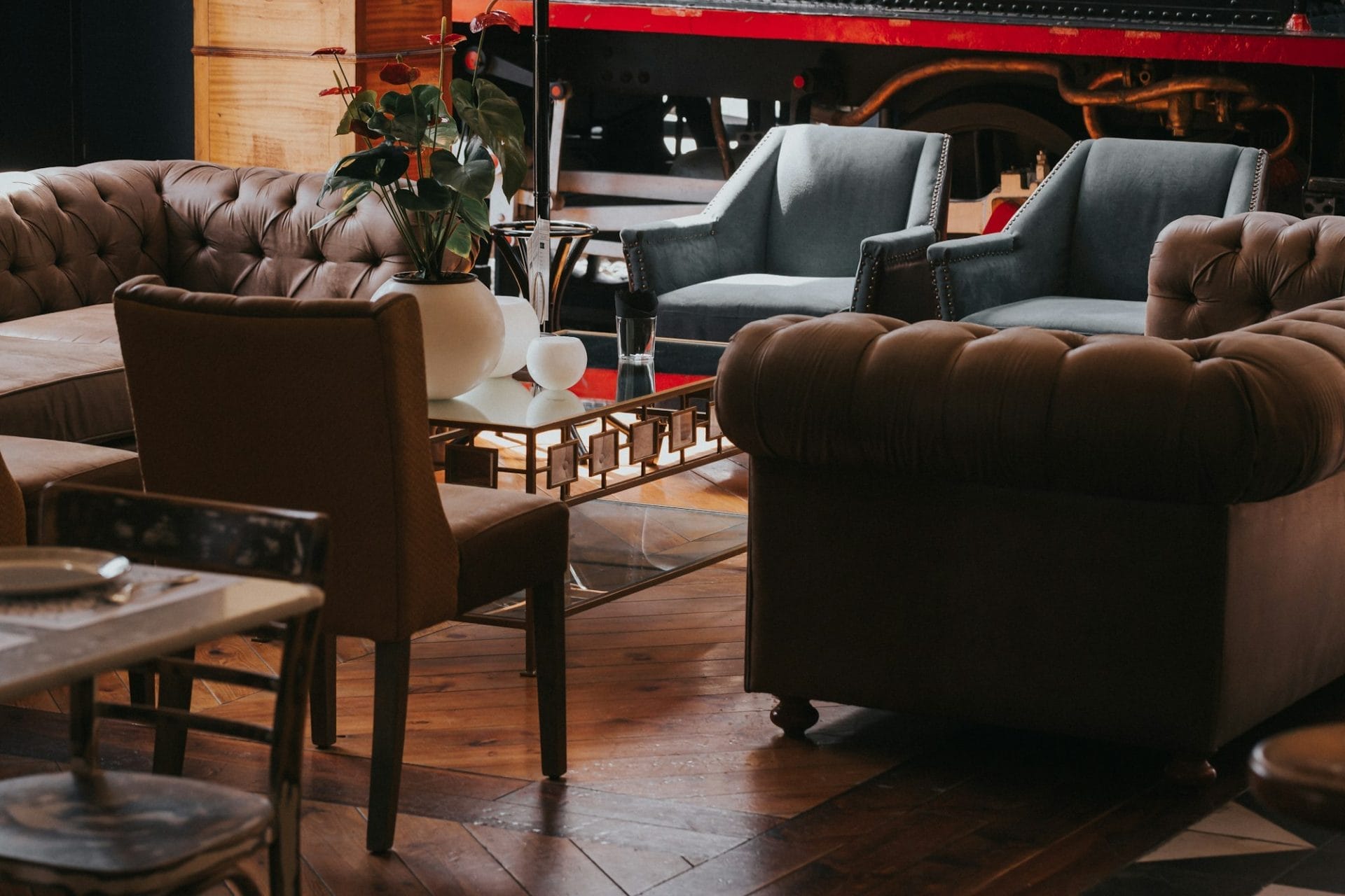 Cozy restaurant interior with modern armchairs and table with flowers